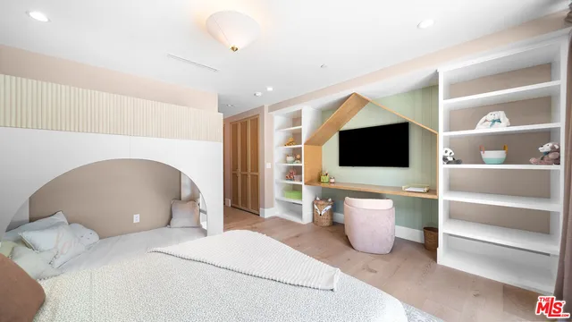 a bedroom with a bed and a flat screen tv