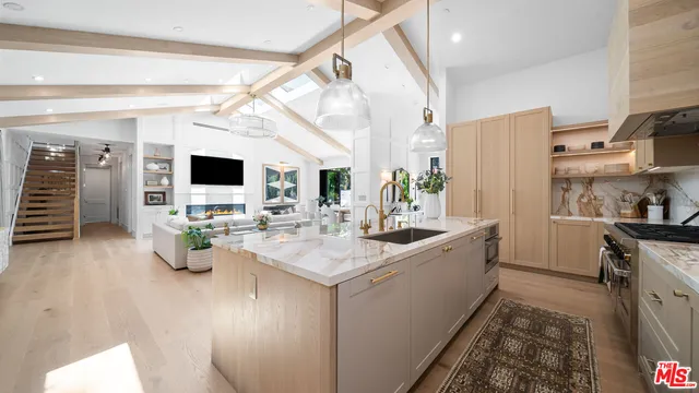 a kitchen with a sink and living room