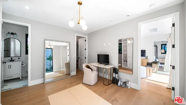 a bedroom with furniture and a chandelier