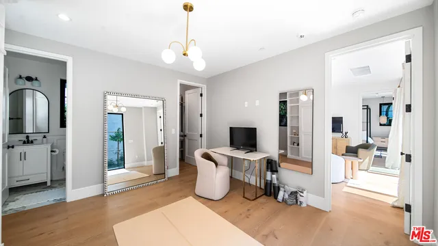 a bedroom with furniture and a chandelier