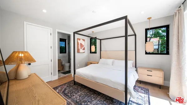 a bedroom with a bed and a mirror