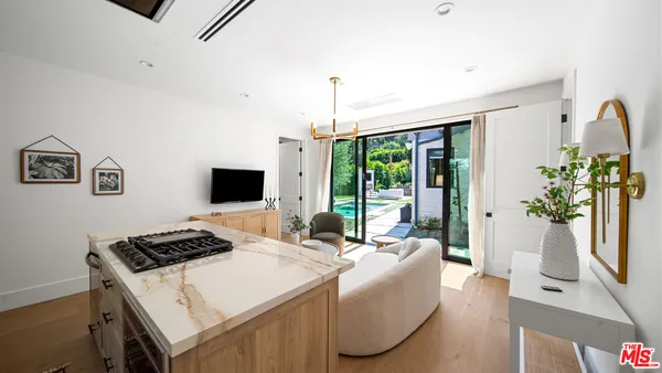 a bedroom with a bed and large windows