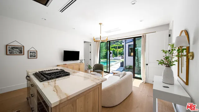 a bedroom with a bed and large windows