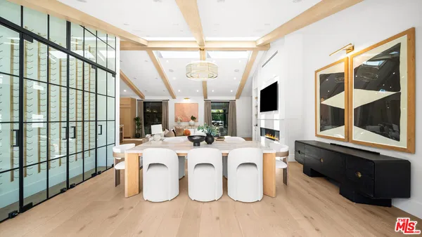 a view of a living room with furniture and flat screen tv