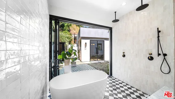 a bathroom with a bathtub and shower