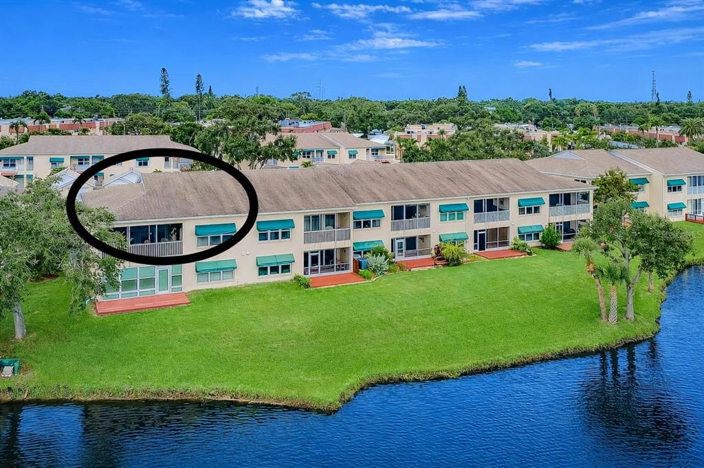 6363 99th Way North, Unit 12I St. Petersburg, FL 33708 - Photo 2 of 69 an aerial view of a house with garden space and outdoor seating