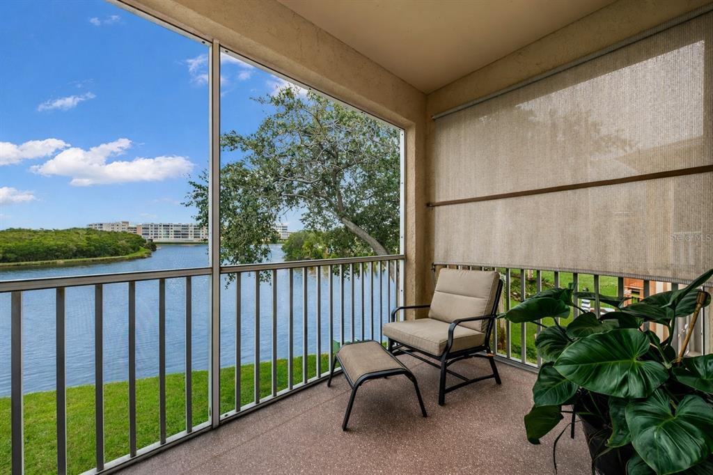 6363 99th Way North, Unit 12I St. Petersburg, FL 33708 - Photo 25 of 69 a balcony with furniture and a potted plant