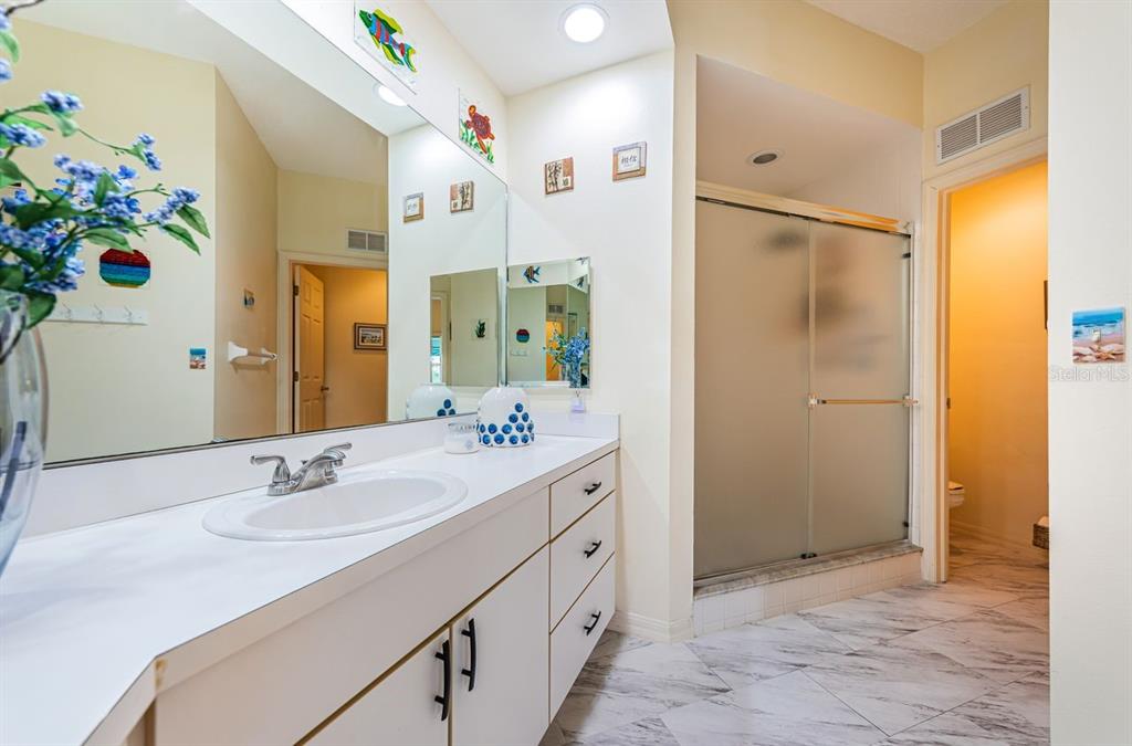 6363 99th Way North, Unit 12I St. Petersburg, FL 33708 - Photo 30 of 69 a bathroom with a sink double vanity and a mirror