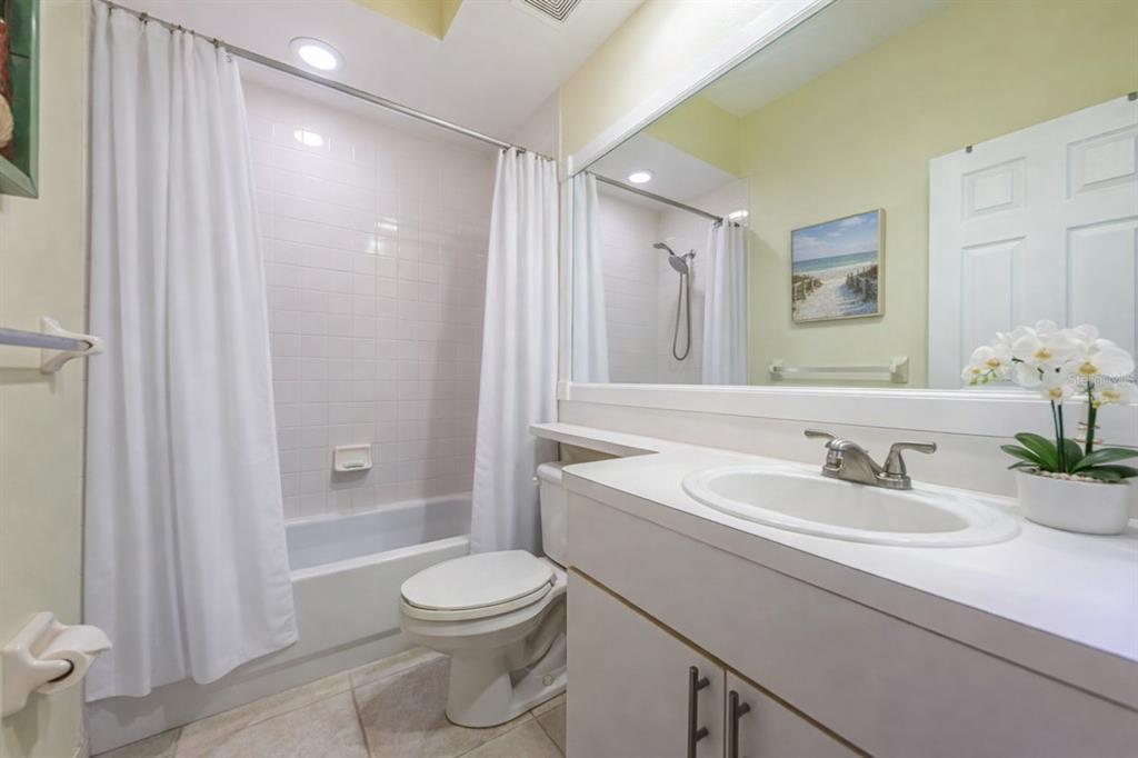 6363 99th Way North, Unit 12I St. Petersburg, FL 33708 - Photo 35 of 69 a bathroom with a sink a toilet and shower