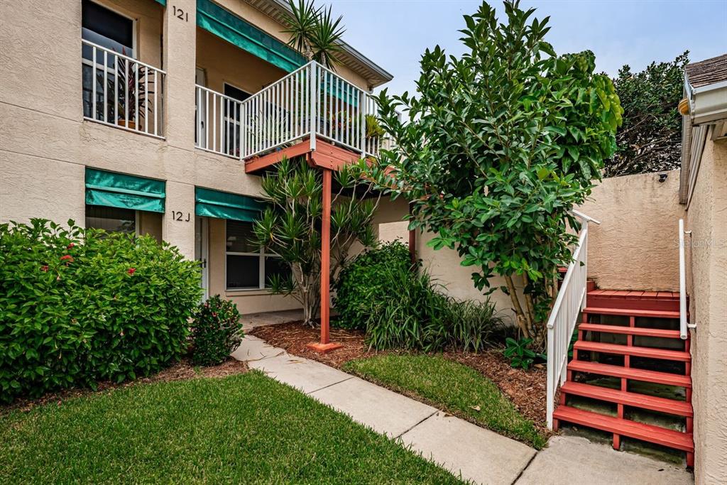 6363 99th Way North, Unit 12I St. Petersburg, FL 33708 - Photo 40 of 69 a front view of a house with a yard