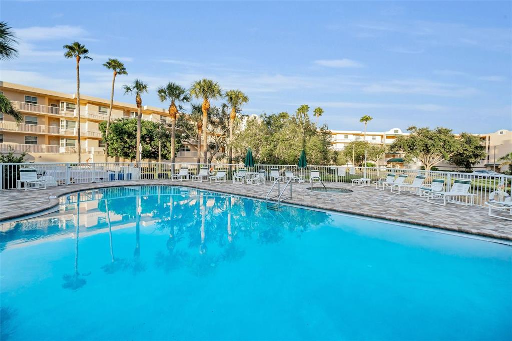 6363 99th Way North, Unit 12I St. Petersburg, FL 33708 - Photo 59 of 69 a swimming pool with outdoor seating and yard