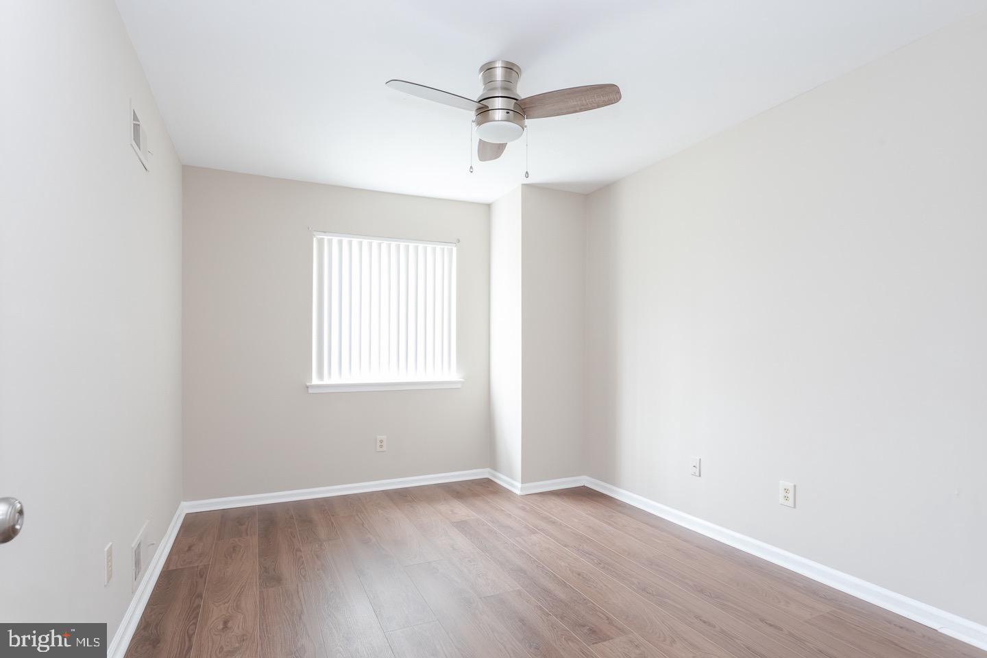118 Caernarvon Court Exton, PA 19341 - Photo 26 of 36 an empty room with wooden floor ceiling fan and windows