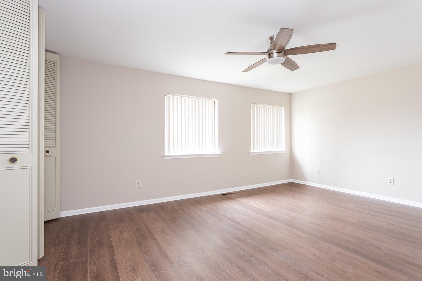 118 Caernarvon Court Exton, PA 19341 - Photo 29 of 36 an empty room with wooden floor fan and windows
