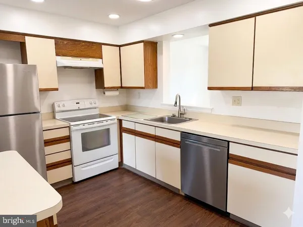 a room with a ceiling fan and wooden floor