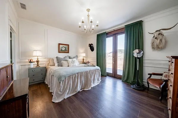 a bedroom with a bed and a chandelier