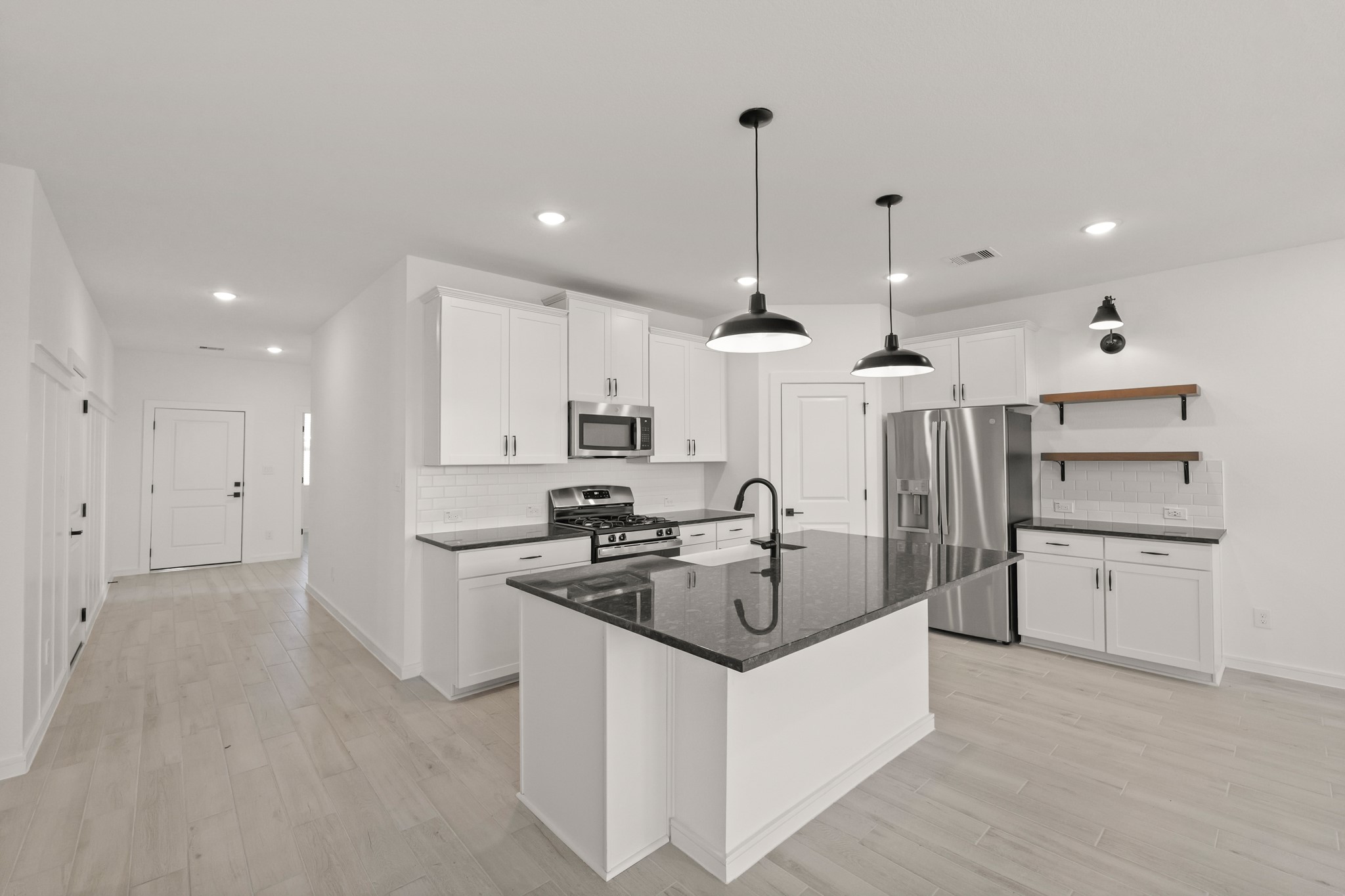 7815 Jade Crest Drive Angleton, TX 77515 - Photo 12 of 38 a kitchen with stainless steel appliances granite countertop a sink a stove and a refrigerator
