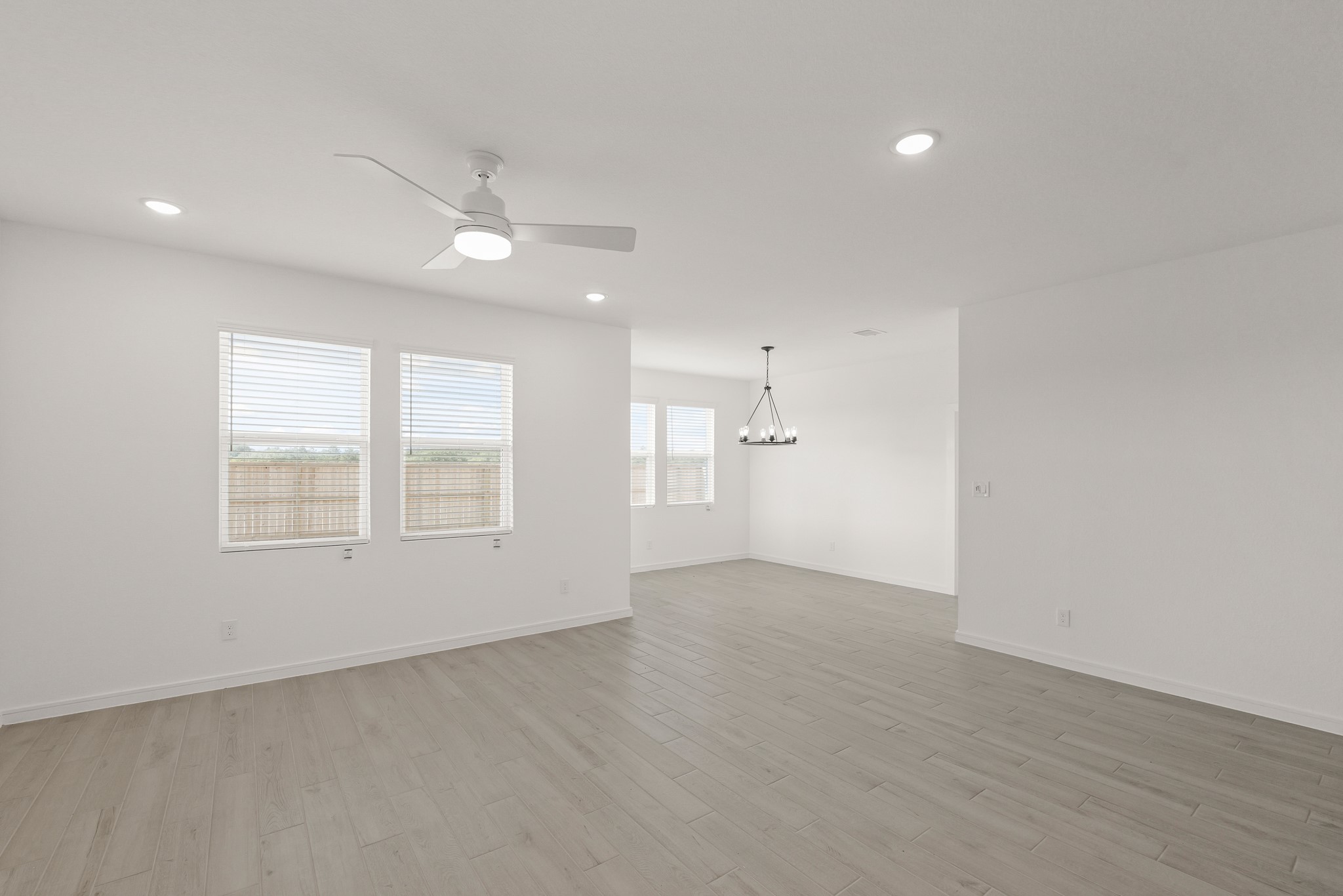 7815 Jade Crest Drive Angleton, TX 77515 - Photo 15 of 38 an empty room with wooden floor and windows
