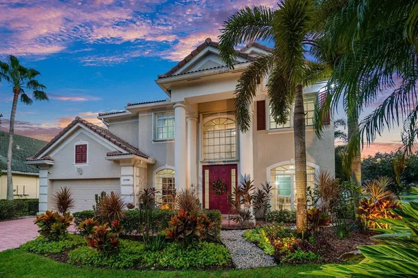 a front view of a house with a garden