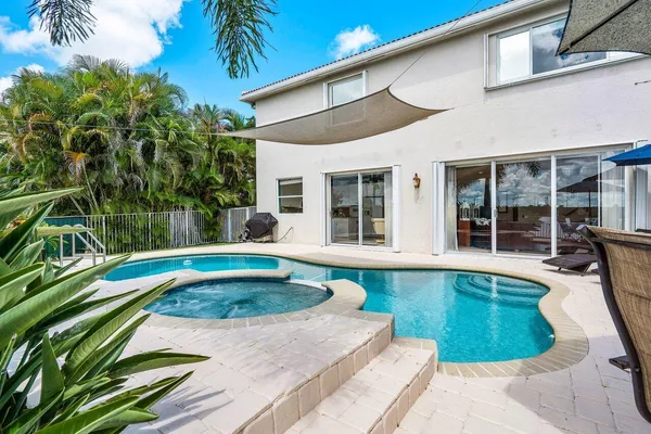 a swimming pool with outdoor seating yard and plants