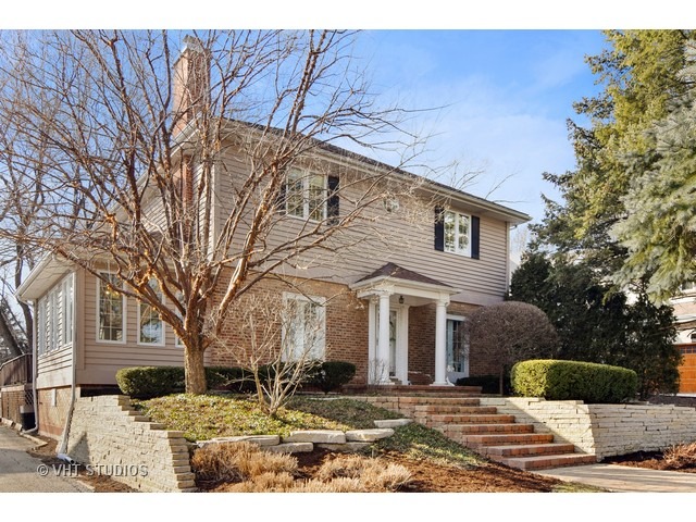 5600 South County Line Road Hinsdale, IL 60521 - Photo 1 of 24 a view of a yard in front of a brick house with large tree