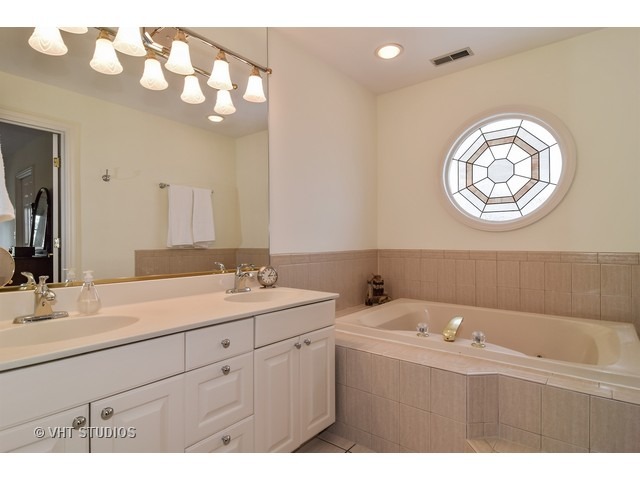 5600 South County Line Road Hinsdale, IL 60521 - Photo 18 of 24 a bathroom with a sink vanity and a mirror