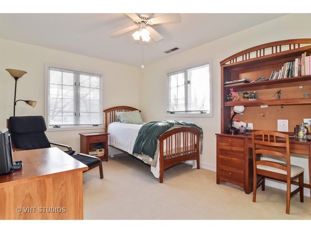 5600 South County Line Road Hinsdale, IL 60521 - Photo 20 of 24 a bedroom with a bed wooden floor and windows