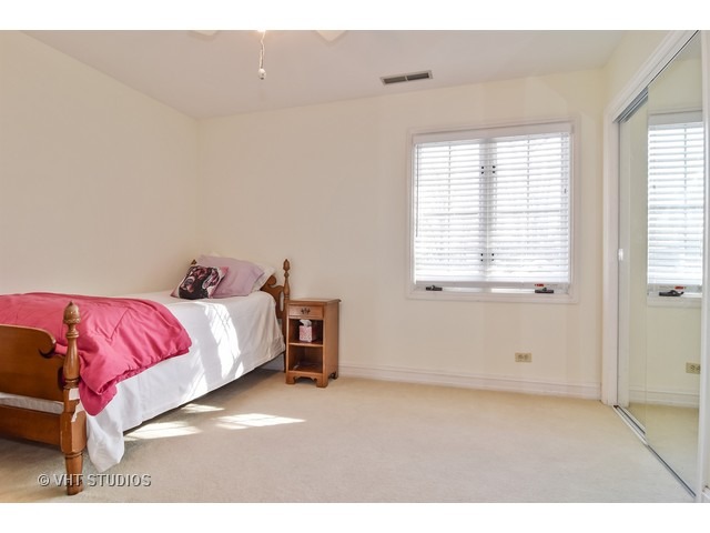 5600 South County Line Road Hinsdale, IL 60521 - Photo 21 of 24 a spacious bedroom with a bed and a window