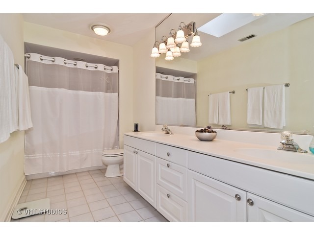 5600 South County Line Road Hinsdale, IL 60521 - Photo 22 of 24 a bathroom with a double vanity sink mirror double and toilet