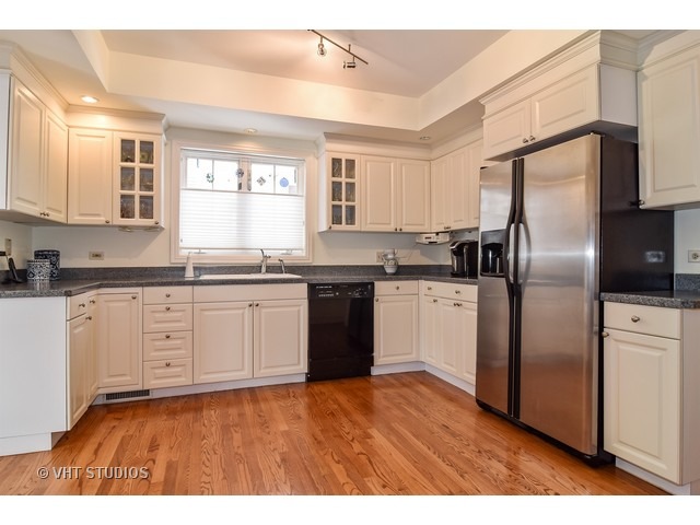 5600 South County Line Road Hinsdale, IL 60521 - Photo 7 of 24 a kitchen with stainless steel appliances granite countertop a refrigerator a sink a stove and white cabinets