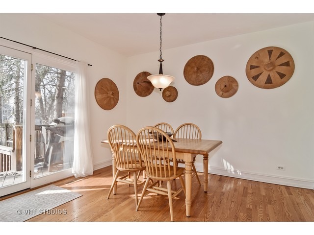 5600 South County Line Road Hinsdale, IL 60521 - Photo 9 of 24 a view of a dining room with furniture and wall clock
