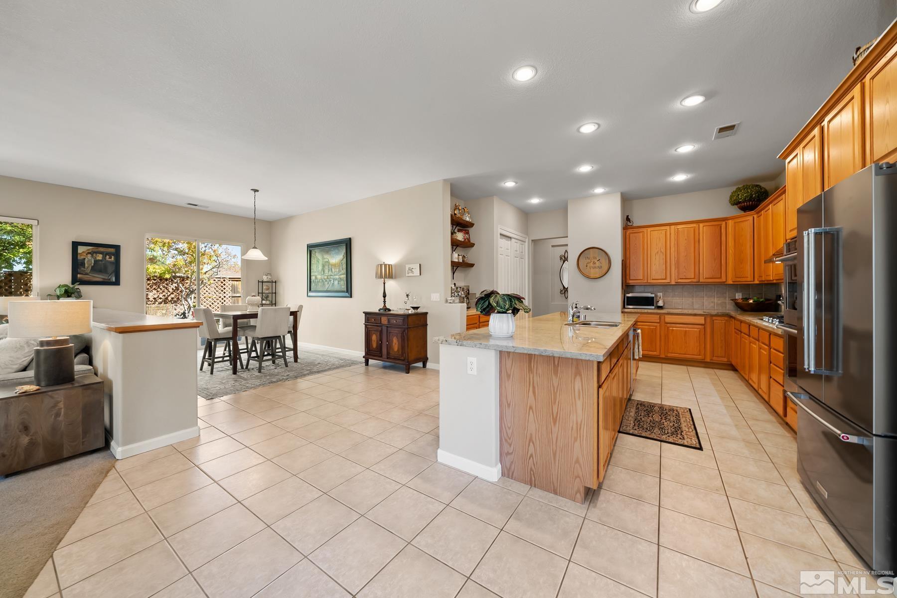 1631 Brightstone Court Reno, NV 89521 - Photo 17 of 40 a living room with furniture a wooden floor and kitchen view