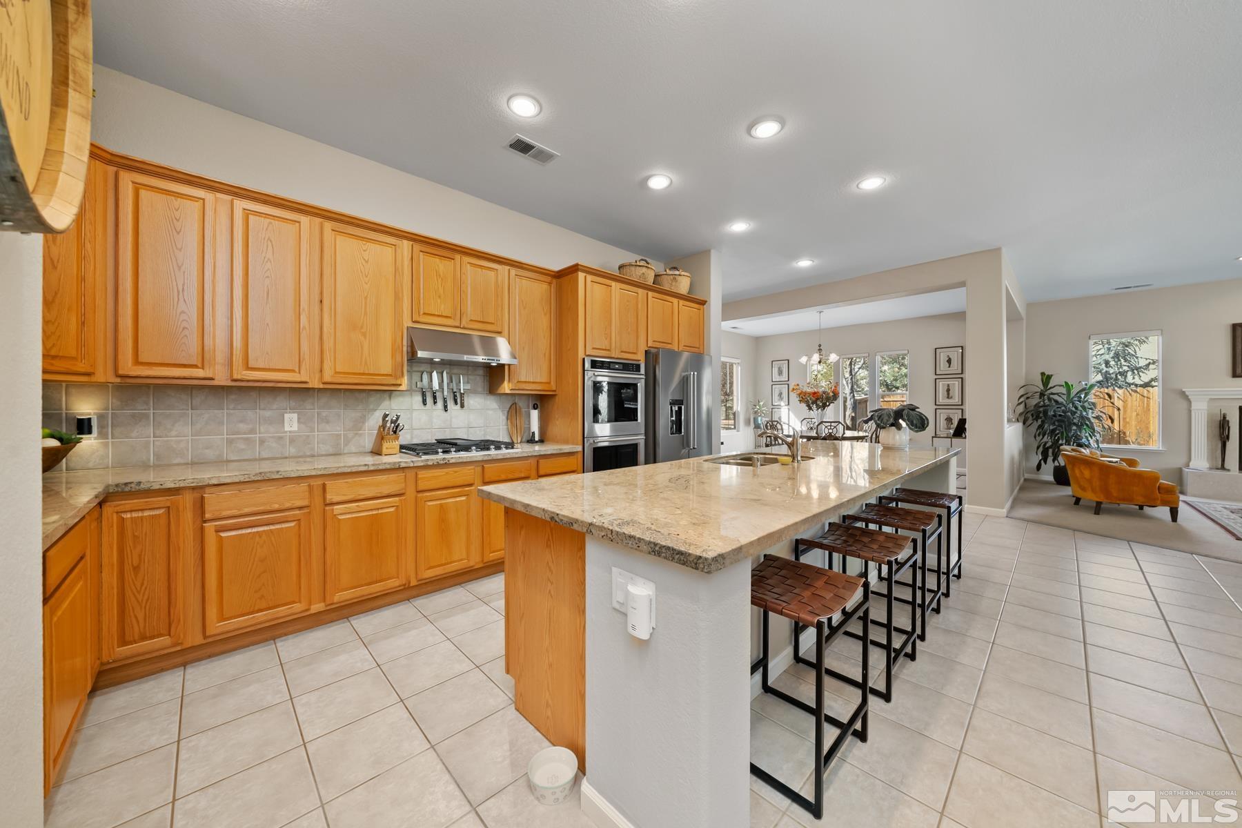 1631 Brightstone Court Reno, NV 89521 - Photo 19 of 40 a kitchen with stainless steel appliances granite countertop a sink and cabinets