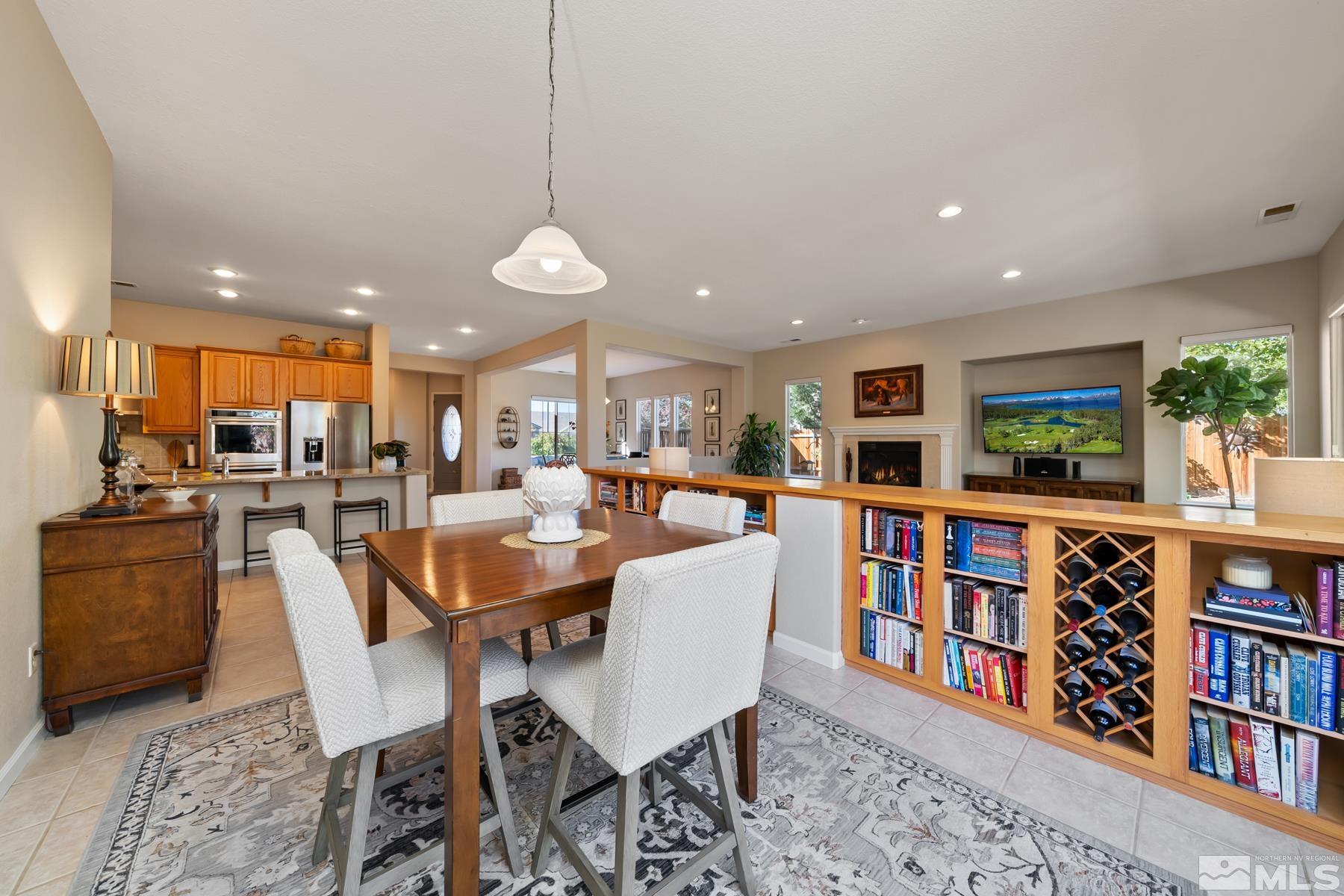 1631 Brightstone Court Reno, NV 89521 - Photo 22 of 40 a dining room with furniture a book shelves and wooden floor