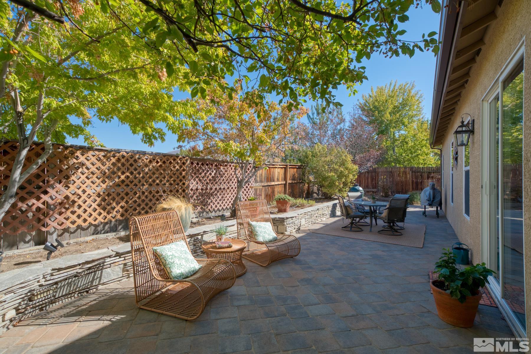1631 Brightstone Court Reno, NV 89521 - Photo 38 of 40 a view of a patio with table and chairs and potted plants