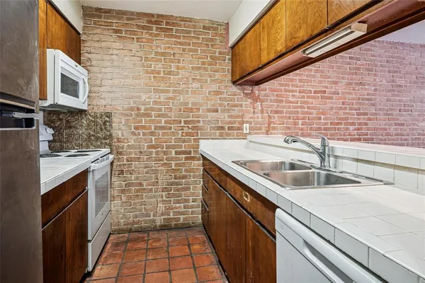 a close up of a microwave stove and a sink