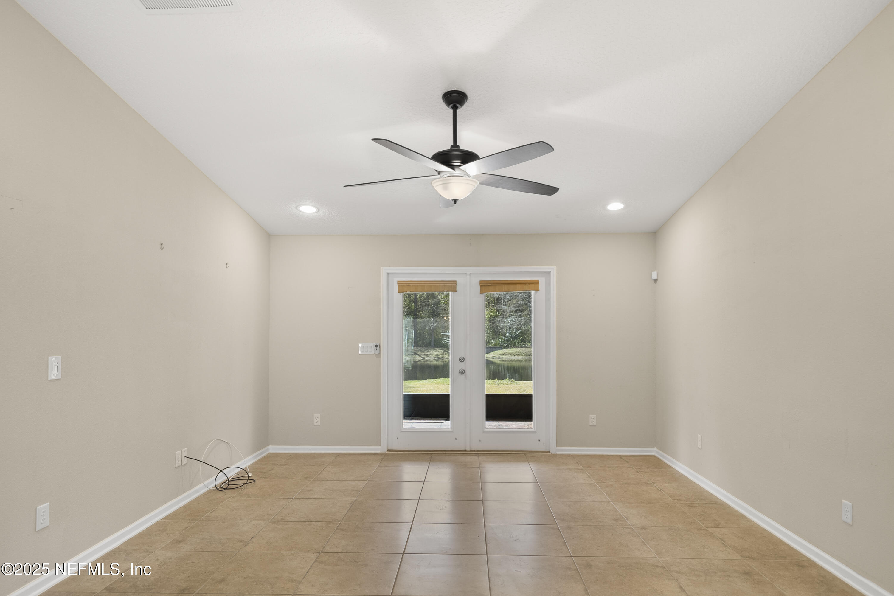 230 Timberwood Drive St. Augustine, FL 32084 - Photo 12 of 34 an empty room with windows and ceiling fan