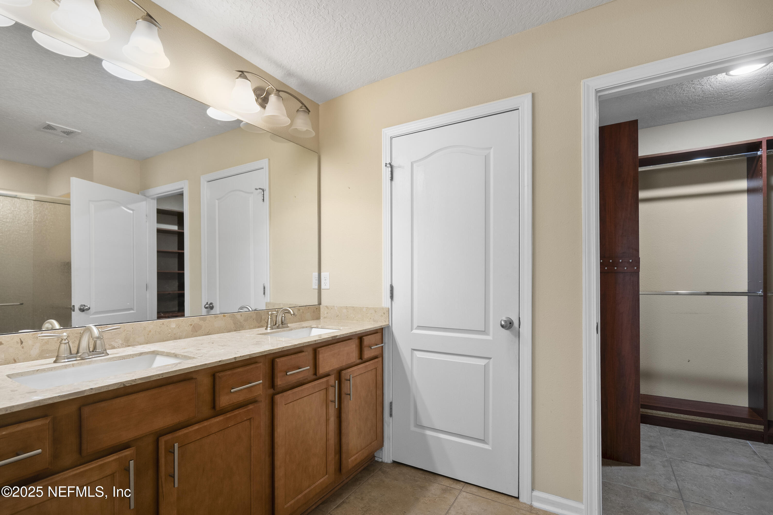 230 Timberwood Drive St. Augustine, FL 32084 - Photo 24 of 34 a bathroom with a double vanity sink and mirror