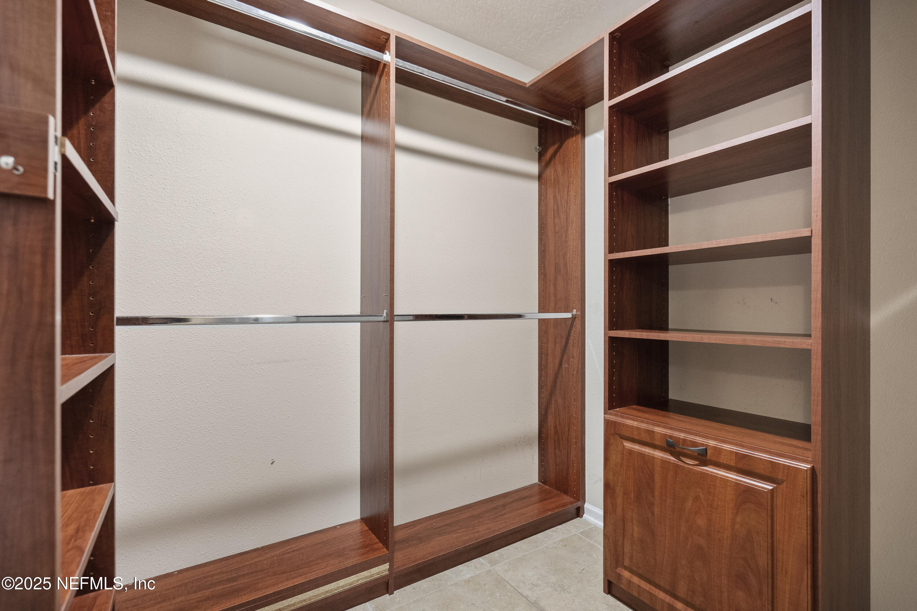 230 Timberwood Drive St. Augustine, FL 32084 - Photo 5 of 34 a view of walk in closet with empty racks