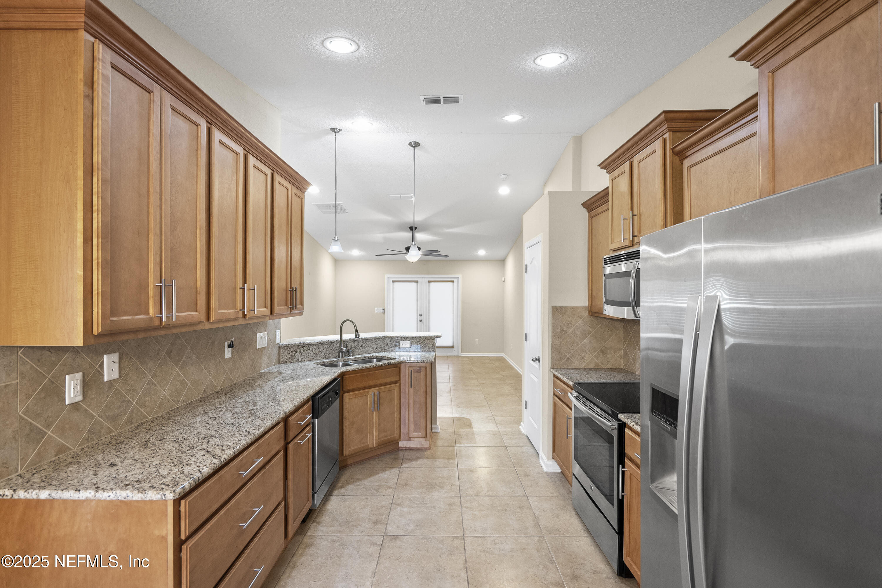 230 Timberwood Drive St. Augustine, FL 32084 - Photo 6 of 34 a large kitchen with stainless steel appliances granite countertop a sink and a refrigerator