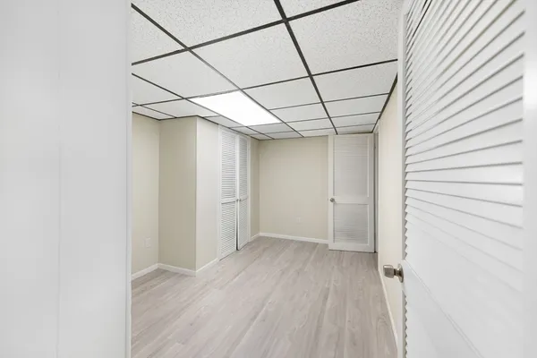 a view of a room with wooden floor