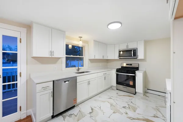 a kitchen with stainless steel appliances granite countertop a sink and cabinets