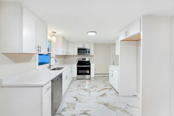 a kitchen with stainless steel appliances a refrigerator sink and cabinets