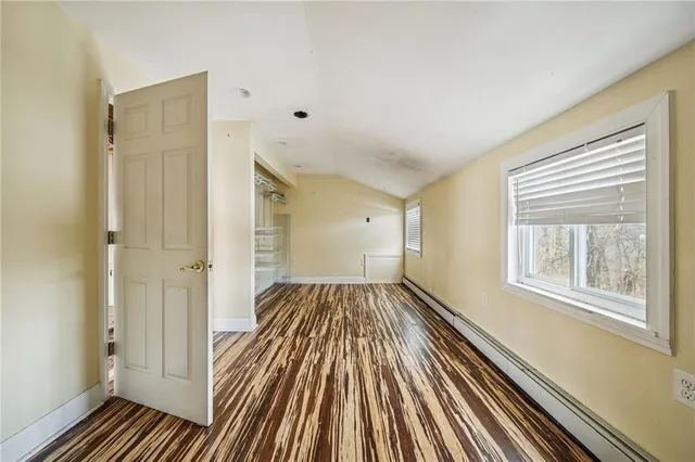 a view of a room with wooden floor and windows