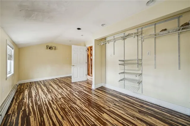 a view of a room with wooden floor