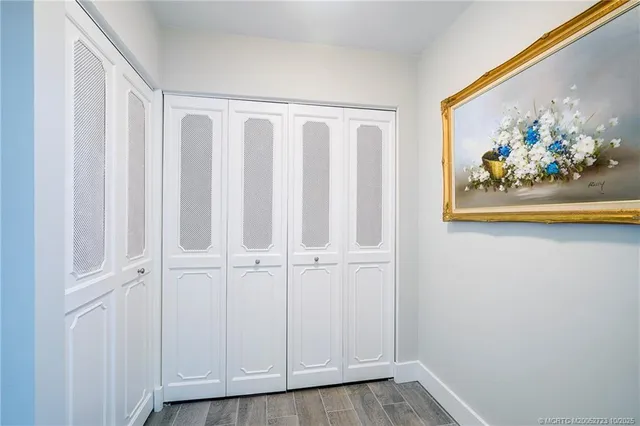 a view of a bedroom with wooden floor and a toilet