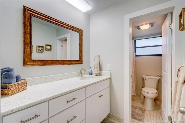 a spacious bedroom with a bed and a flat screen tv