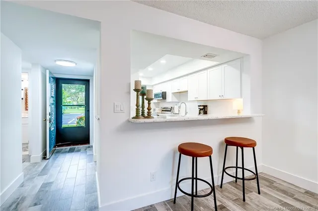 a kitchen with granite countertop stainless steel appliances and cabinets