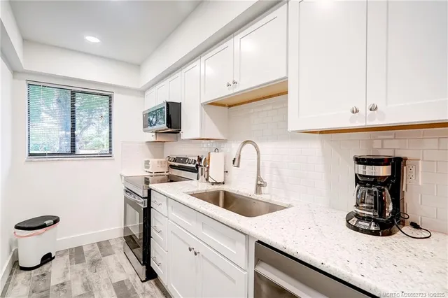 a living room with furniture and a lamp