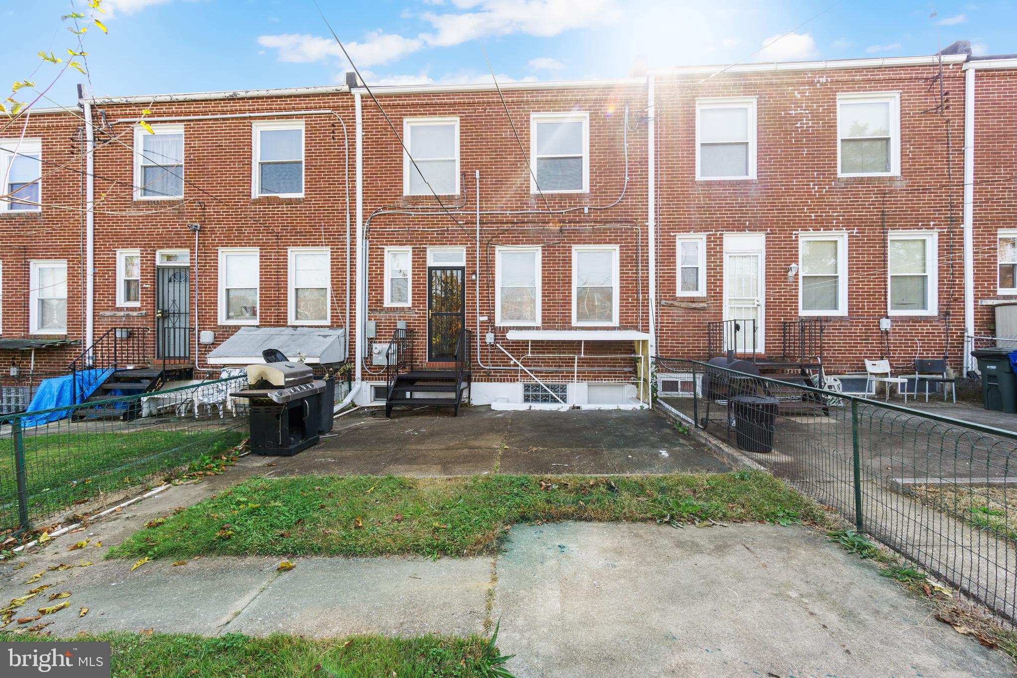 3572 Juneway, Unit 1 Baltimore, MD 21213 - Photo 20 of 23 a view of a brick building with many windows and garden