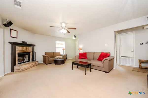 a living room with furniture and a fireplace